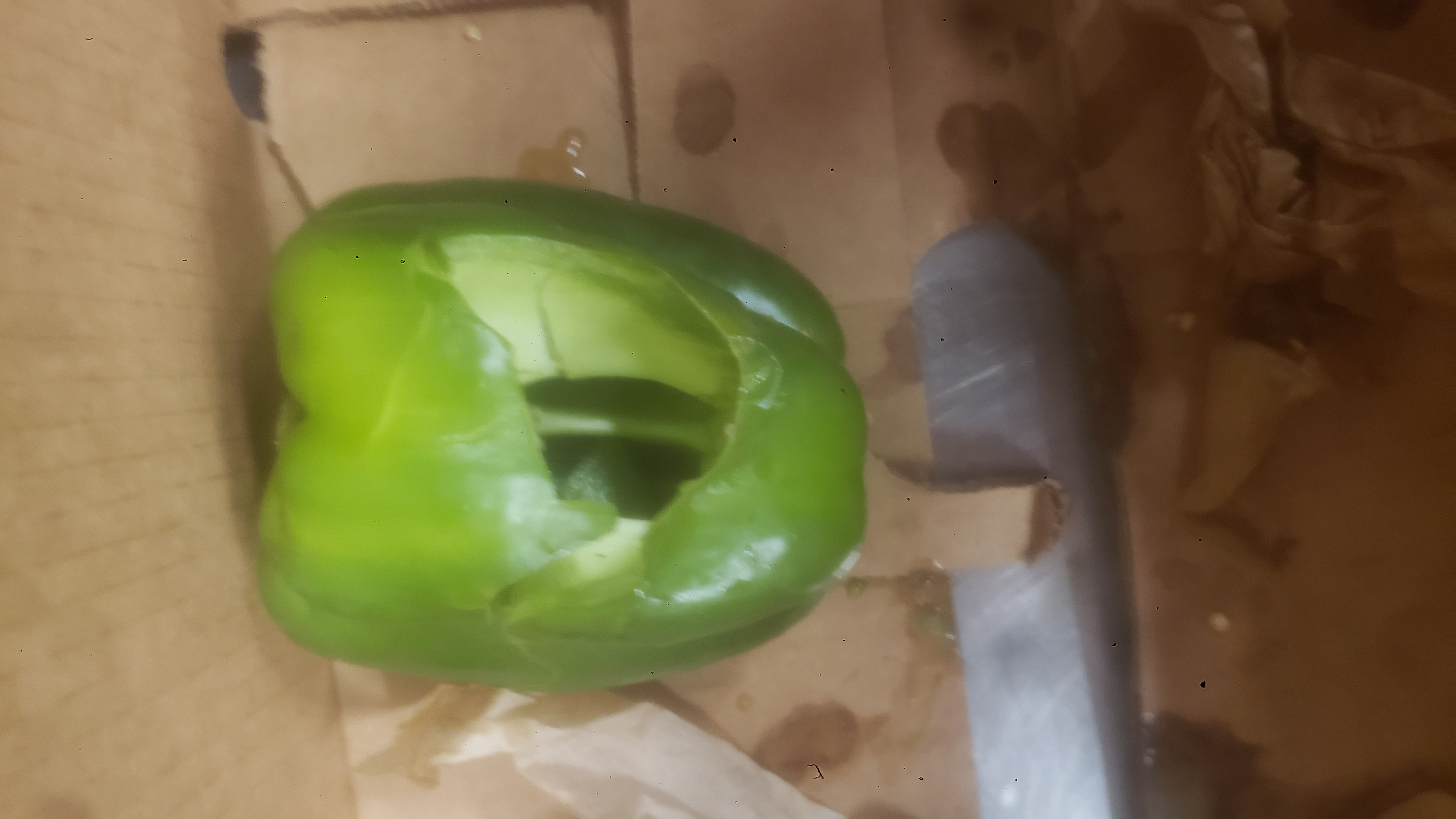 Broken bellpepper on the handle side of a banana box.
